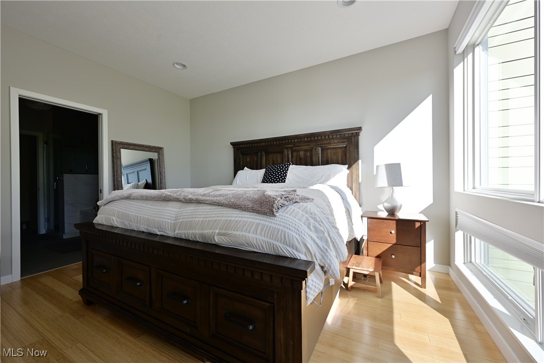 18875 Riversouth Fairview Park, Unit 30 Cleveland, OH 44126 - Photo 22 of 39 Bedroom with multiple windows, light wood-style flooring, and recessed lighting