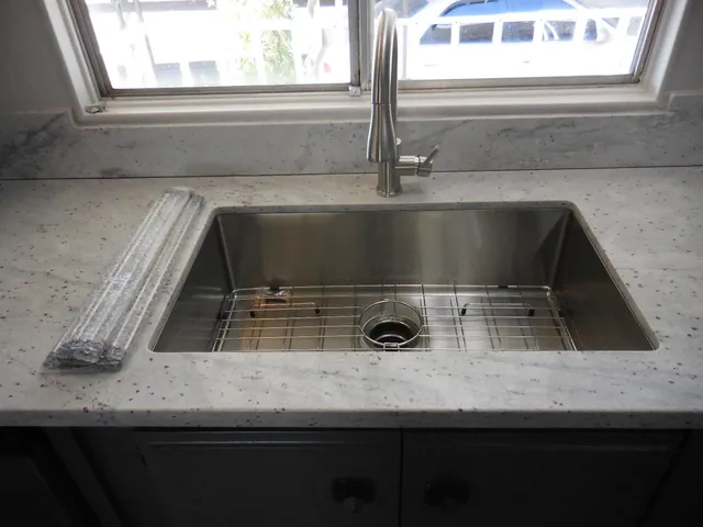 a kitchen with a sink a window and a microwave