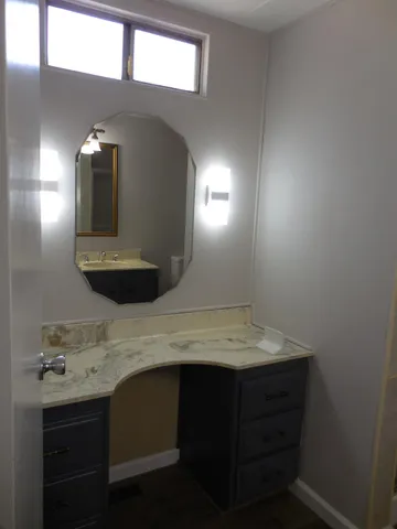 a bathroom with a glass shower door