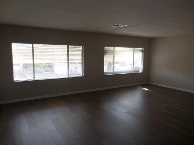 wooden floor in an empty room with a bathroom