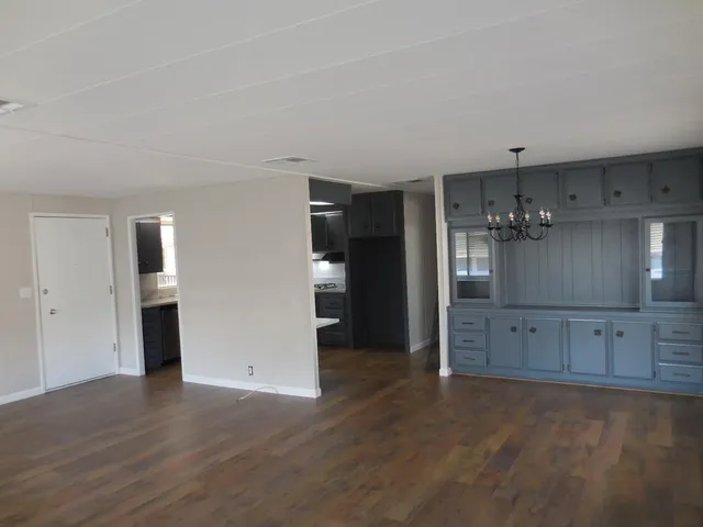 a large kitchen with a stove and a refrigerator