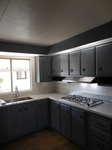 a kitchen with granite countertop cabinets and black appliances