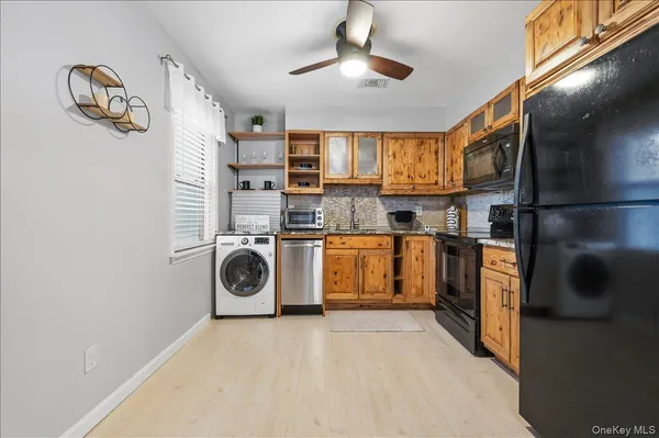 a kitchen with stainless steel appliances granite countertop a refrigerator a sink and a stove