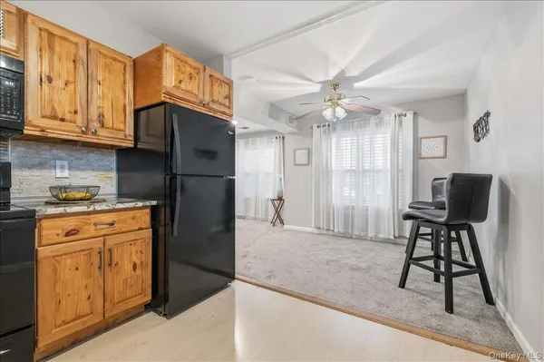 a kitchen with stainless steel appliances granite countertop a refrigerator a stove and a sink with granite countertops