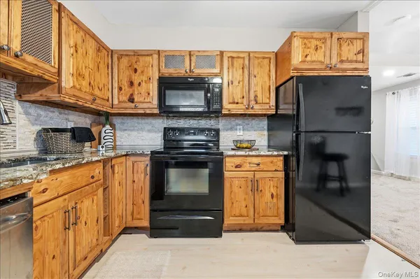 a kitchen with stainless steel appliances granite countertop a refrigerator stove and sink