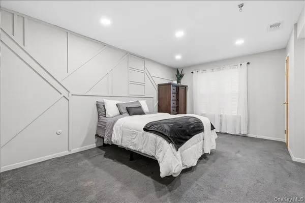 a spacious bedroom with a bed and a closet