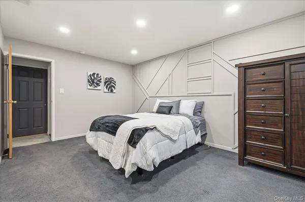 a spacious bedroom with a bed and a cabinets