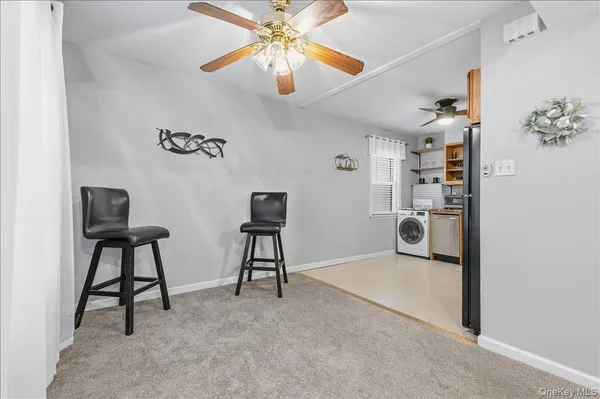 a view of a livingroom with furniture and a chandelier fan
