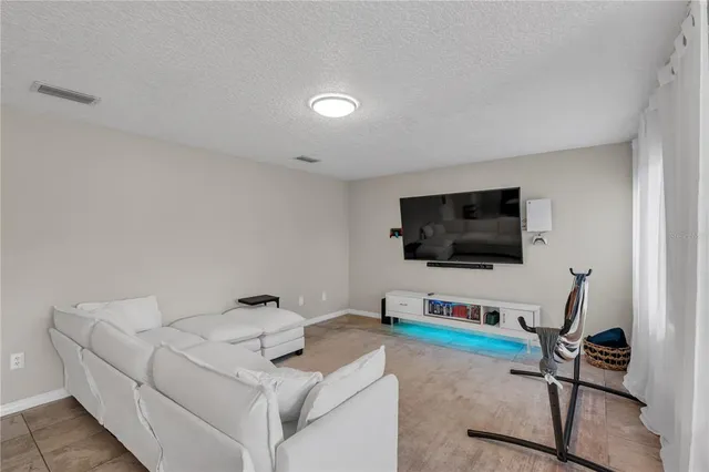 a bedroom with furniture and a large window