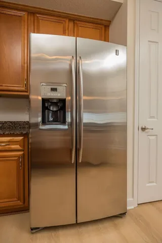 a view of a room with wooden floor and chandelier