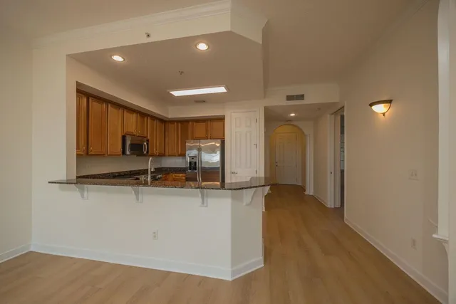 a view of empty room with wooden floor and window