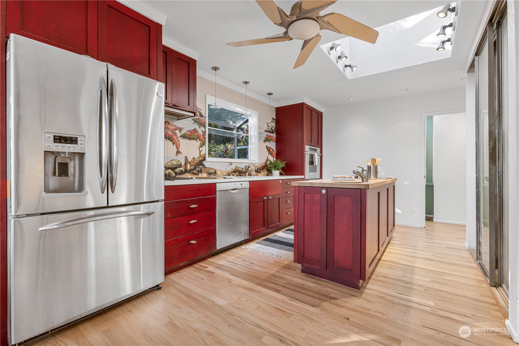 436 36th Avenue Seattle, WA 98122 - Photo 12 of 39 a kitchen with stainless steel appliances a refrigerator and a stove top oven