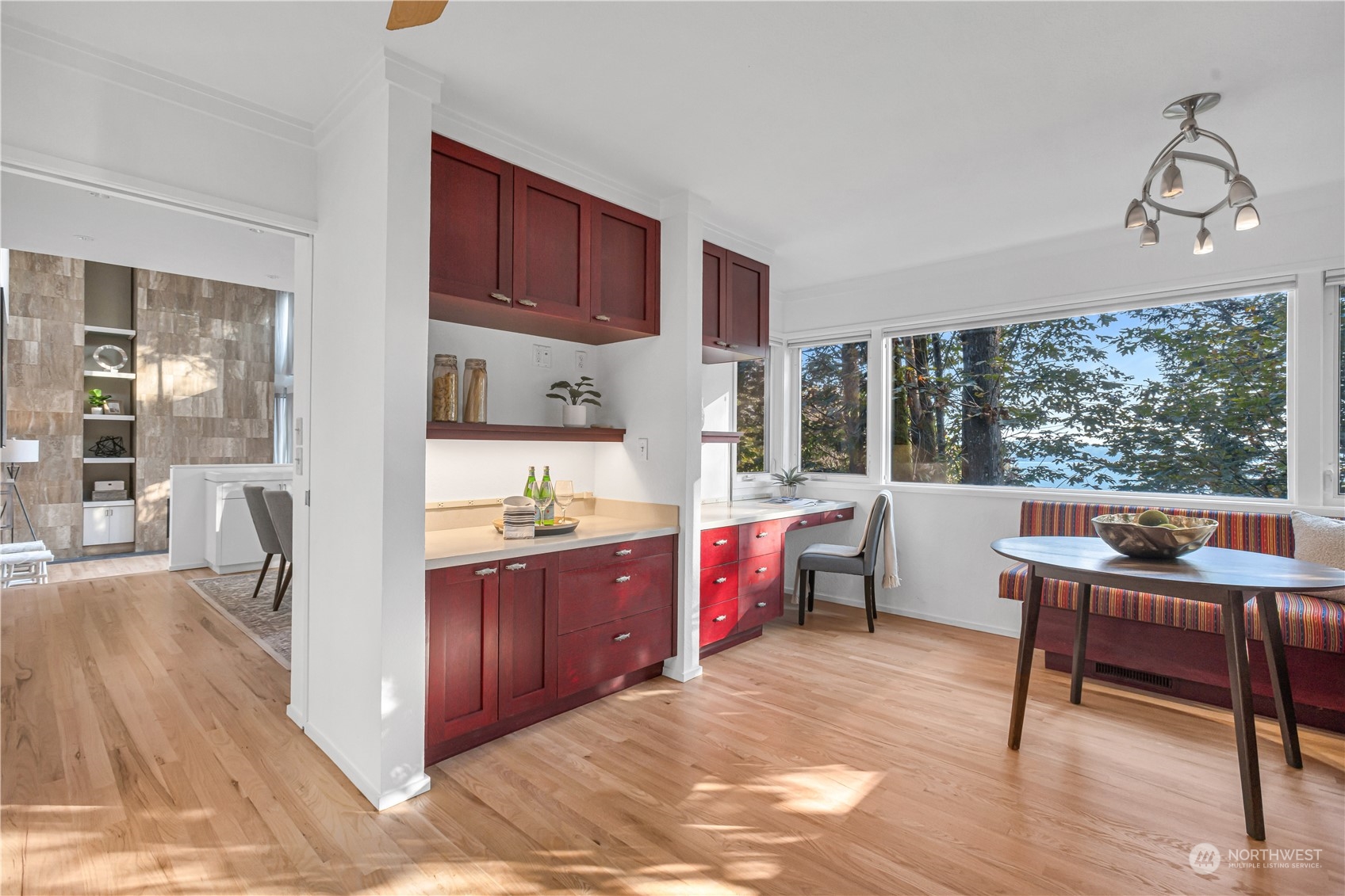 436 36th Avenue Seattle, WA 98122 - Photo 14 of 39 a kitchen with kitchen island granite countertop a stove a refrigerator a sink a dining table and chairs with wooden floor