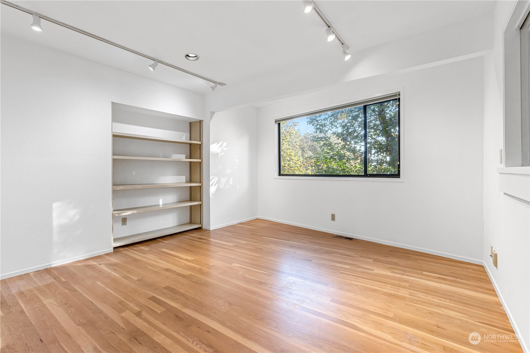 436 36th Avenue Seattle, WA 98122 - Photo 25 of 39 a view of empty room with window and wooden floor