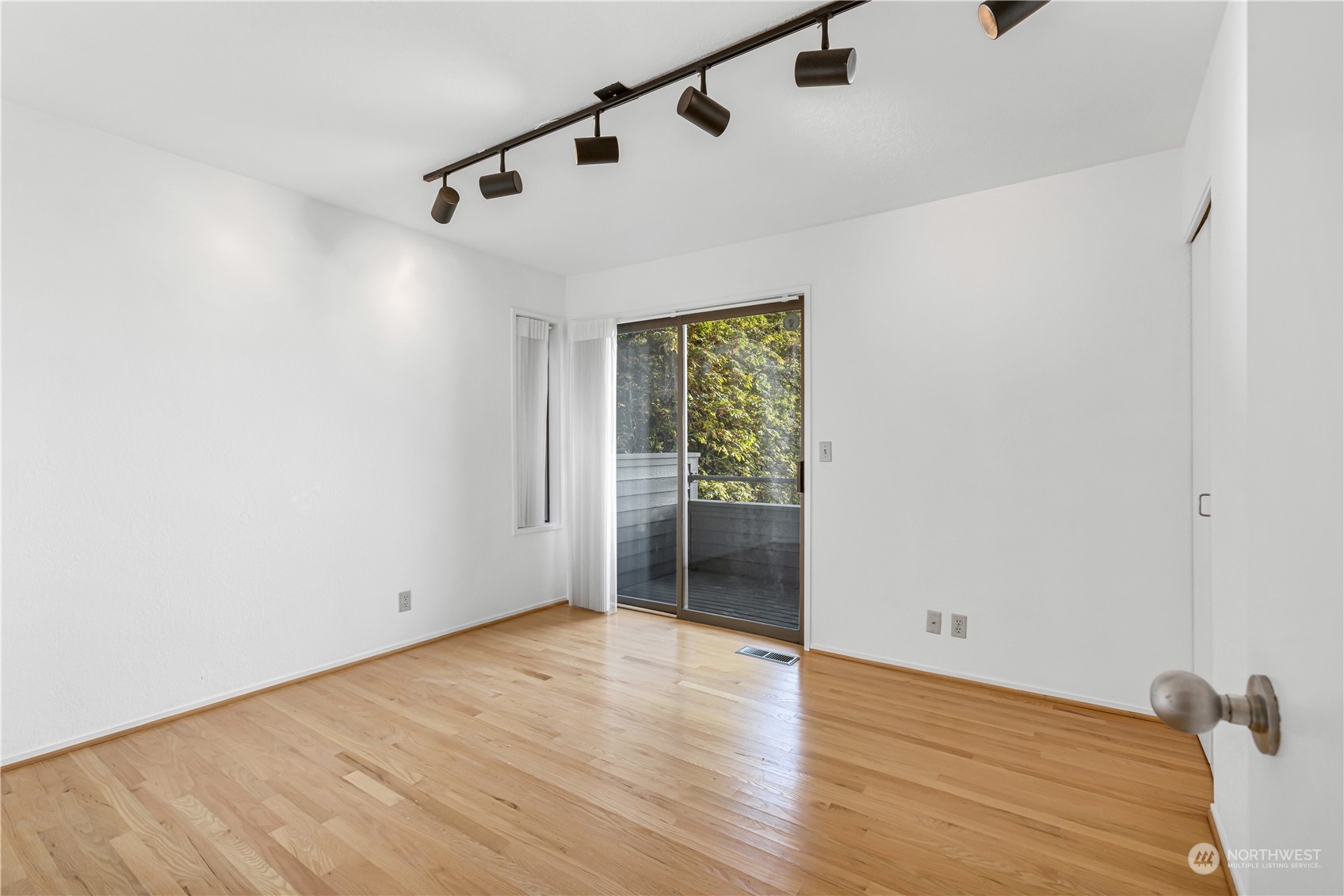 436 36th Avenue Seattle, WA 98122 - Photo 26 of 39 a view of an empty room with wooden floor and a window