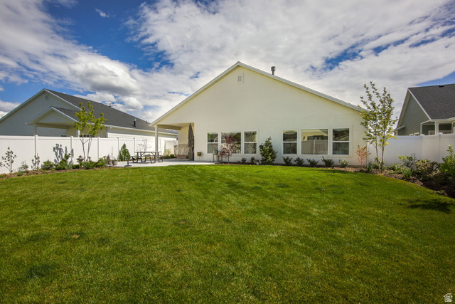 910 South 1700 West Layton, UT 84041 - Photo 23 of 26 Rear view of house featuring a fenced backyard, a patio area, and stucco siding