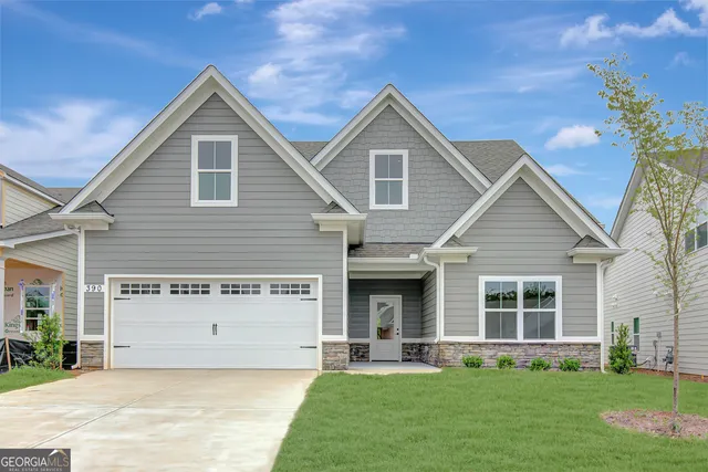 a view of a house with a yard and sitting area