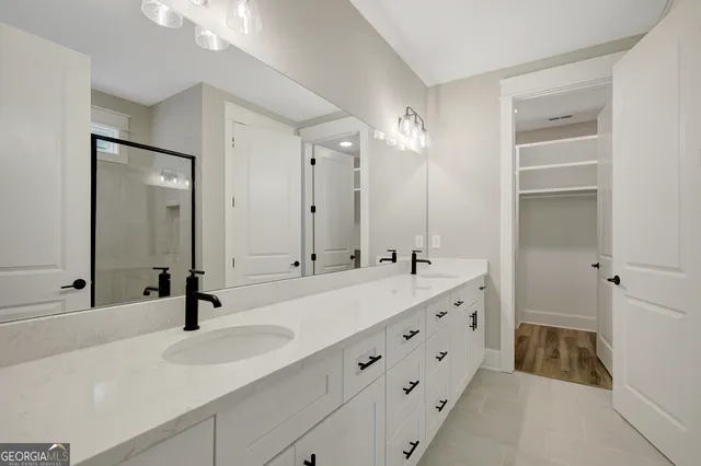 a bathroom with double vanity sink and mirror