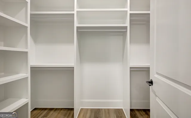 a view of closet with wooden floor
