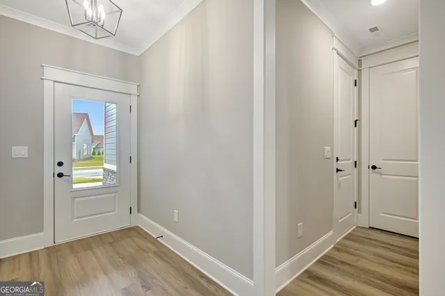 a view of an empty room with closet and a window