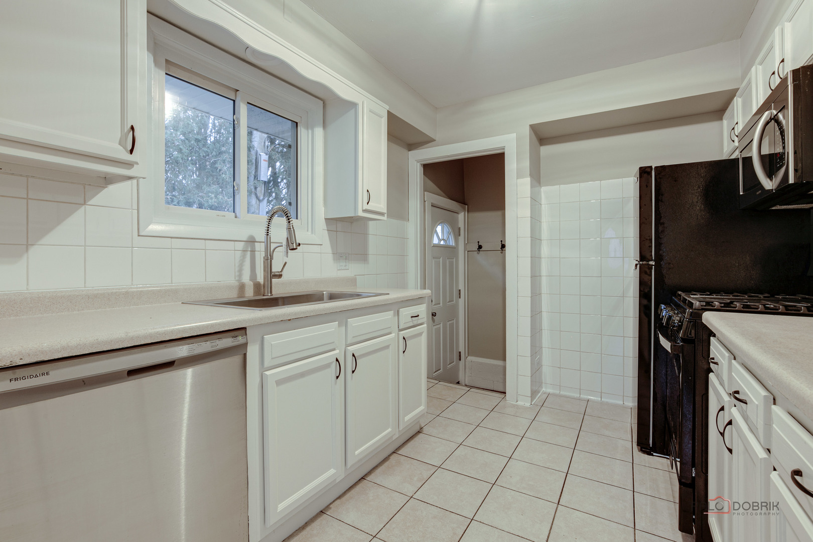 1595 North McKinley Road, Unit 1 Lake Forest, IL 60045 - Photo 12 of 24 a kitchen with a sink and a refrigerator