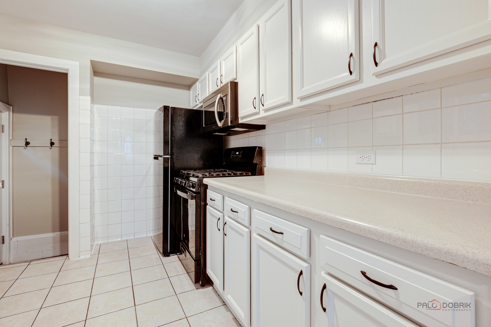 1595 North McKinley Road, Unit 1 Lake Forest, IL 60045 - Photo 13 of 24 a kitchen with white cabinets and appliances