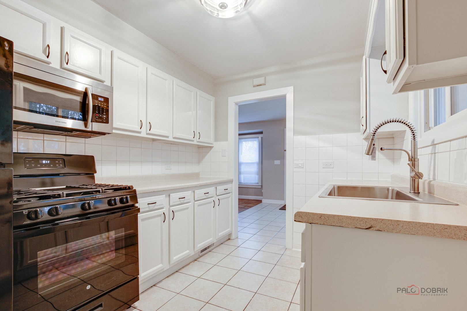 1595 North McKinley Road, Unit 1 Lake Forest, IL 60045 - Photo 14 of 24 a kitchen with stainless steel appliances a stove sink and cabinets