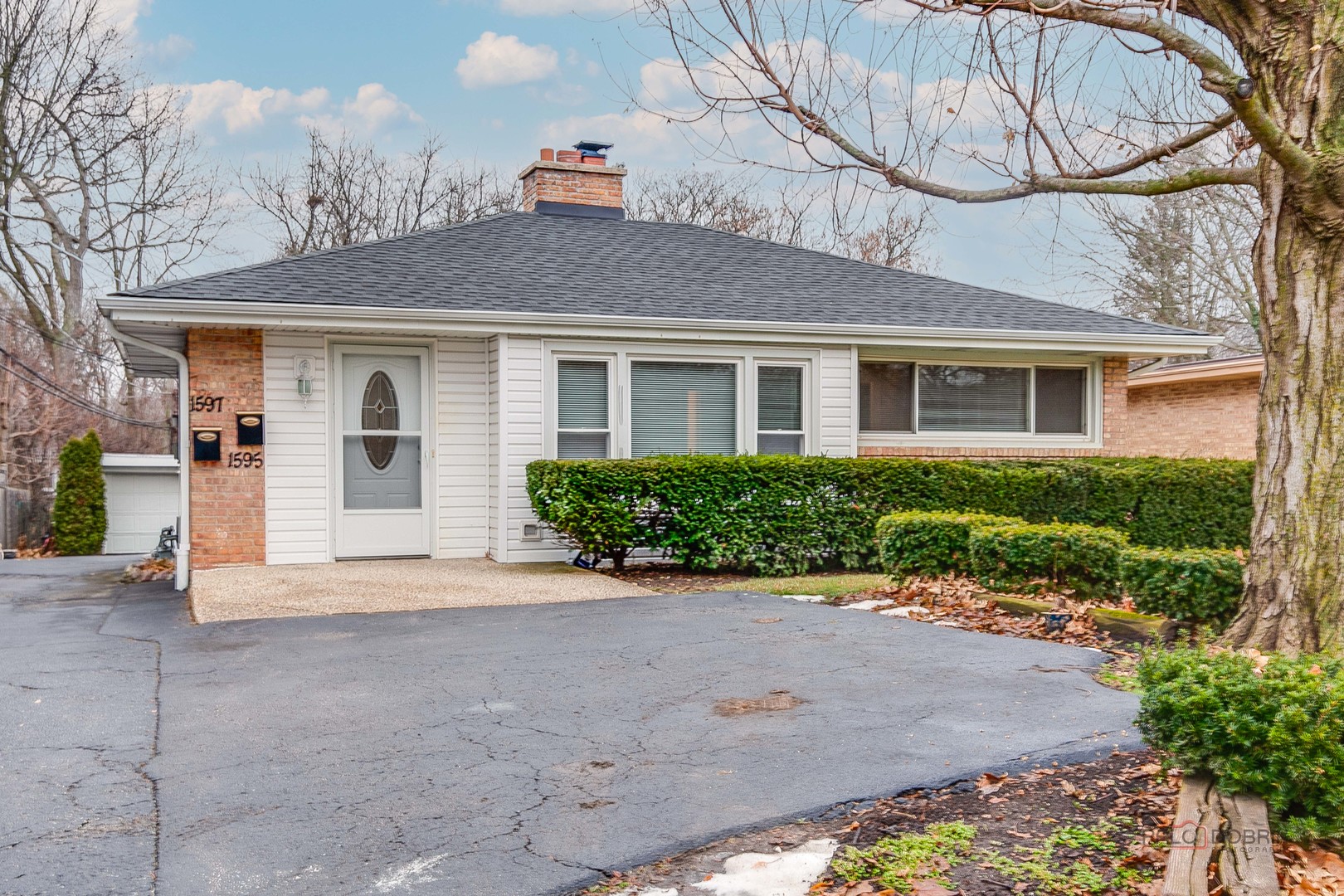 1595 North McKinley Road, Unit 1 Lake Forest, IL 60045 - Photo 3 of 24 a front view of a house with a yard and potted plants