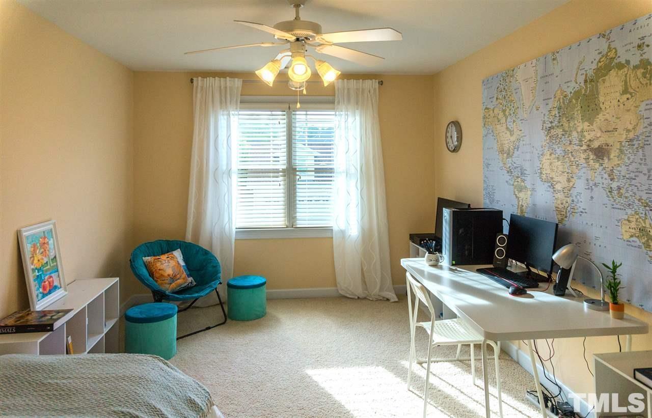 403 Homegate Circle Apex, NC 27502 - Photo 11 of 14 a living room with furniture a flat screen tv and a window