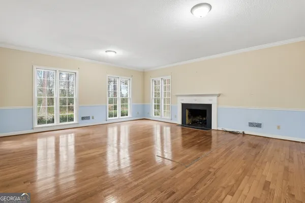 a view of an empty room with a chandeliers