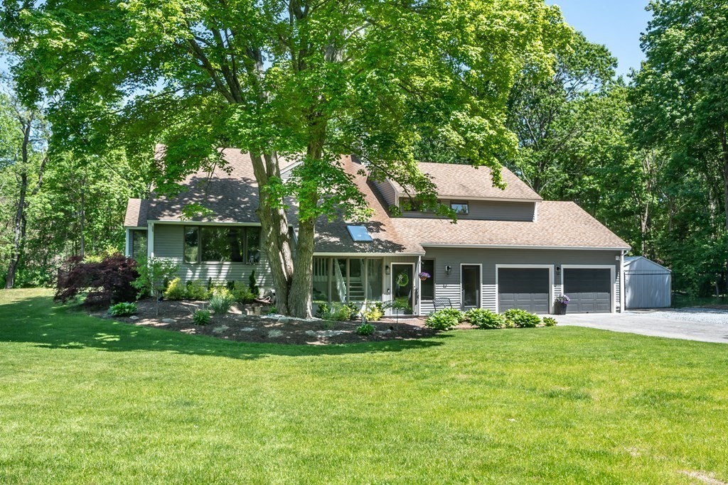 a front view of a house with a yard table and chairs
