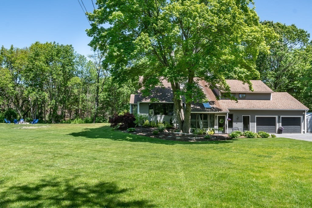 50 Ash Street Rehoboth, MA 02769 - Photo 2 of 34 a front view of a house with a yard table and chairs