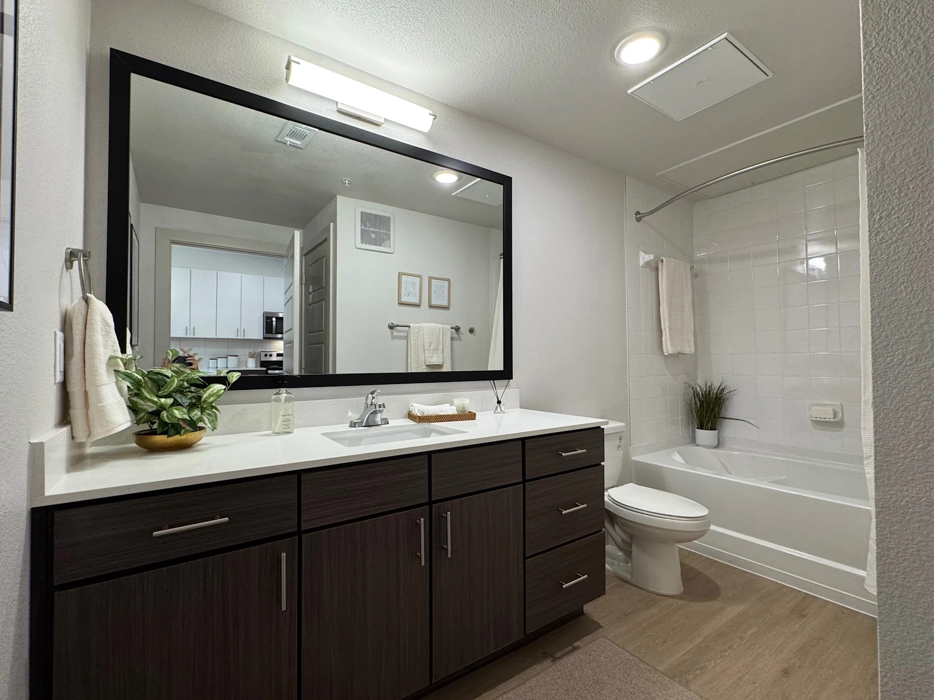 320 Goll Street, Unit 2233 Kyle, TX 78640 - Photo 7 of 19 a bathroom with a double vanity sink a toilet and a mirror