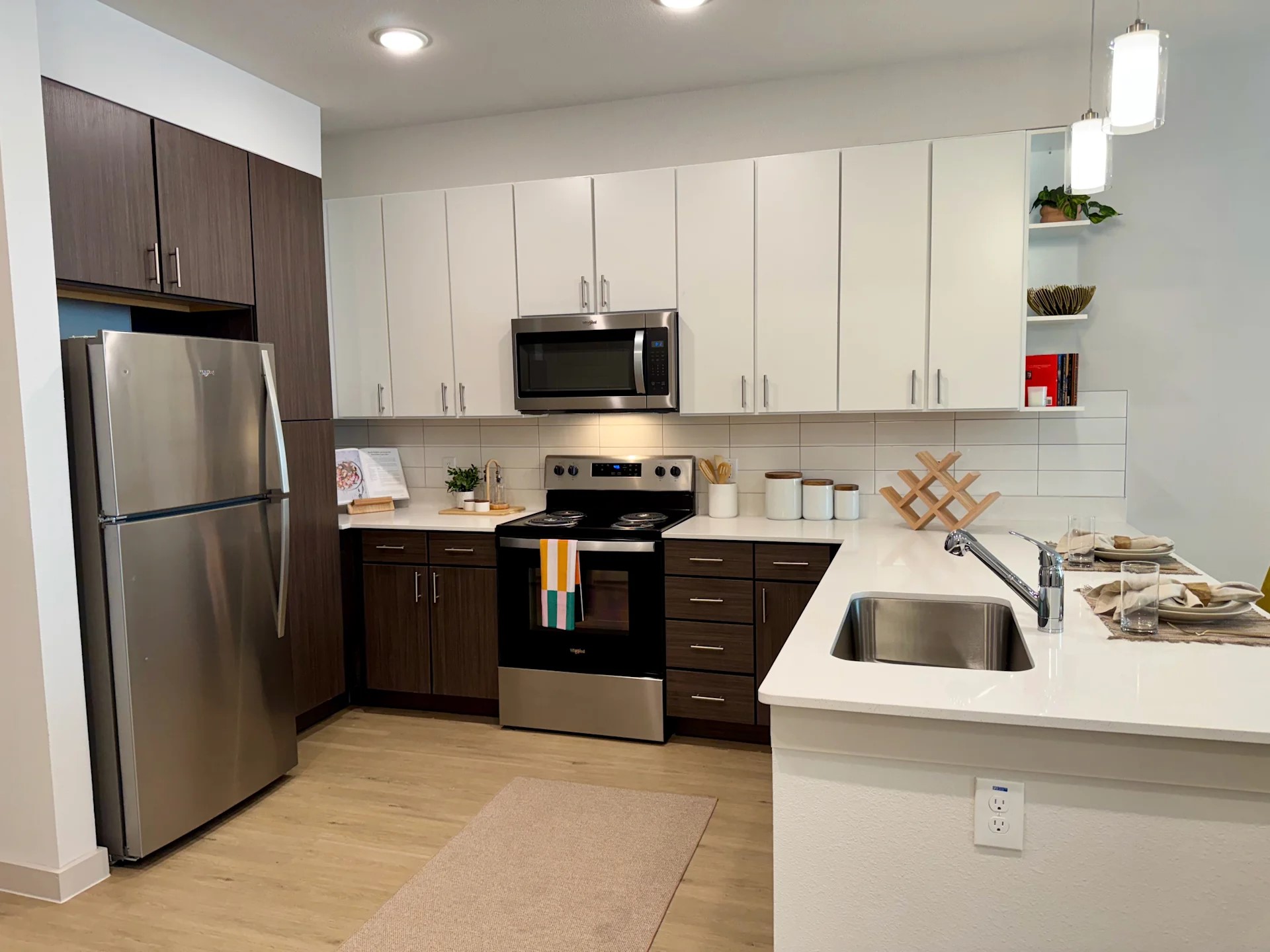 320 Goll Street, Unit 2233 Kyle, TX 78640 - Photo 10 of 19 a kitchen with granite countertop a refrigerator sink and white cabinets