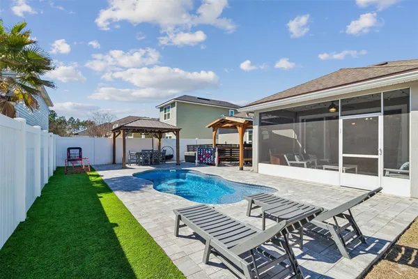 a view of a house with backyard porch and sitting area