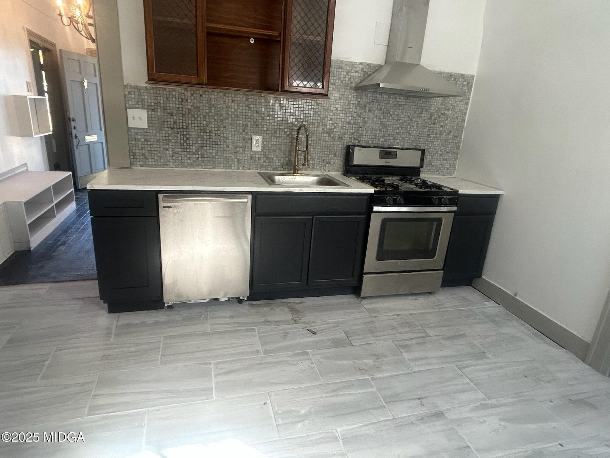 832 Elm Street Macon, GA 31201 - Photo 3 of 6 a kitchen with stainless steel appliances granite countertop a stove a sink and a microwave