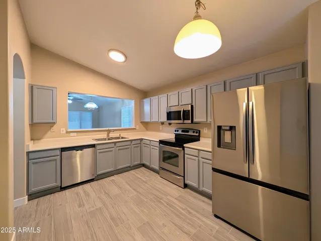 a kitchen with a sink stove and refrigerator