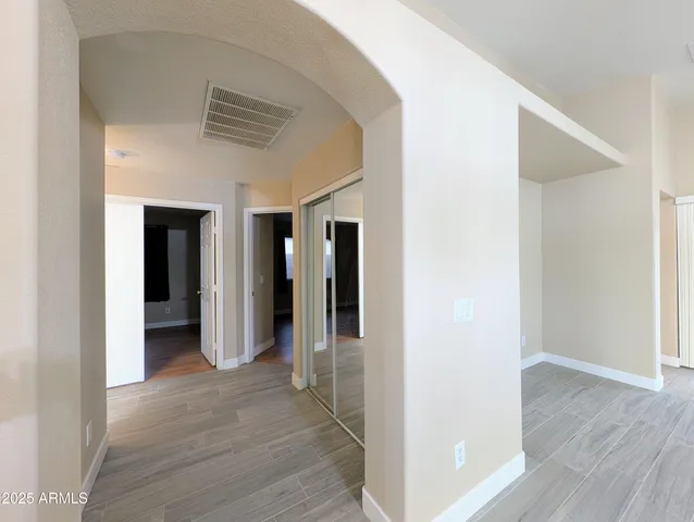 a view of hallway with wooden floor