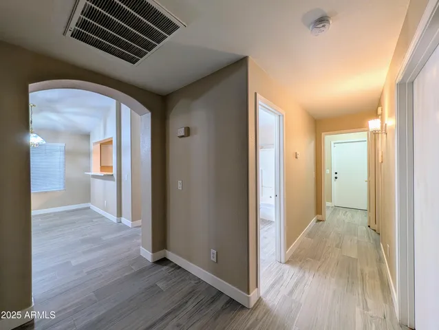 a view of hallway with wooden floor