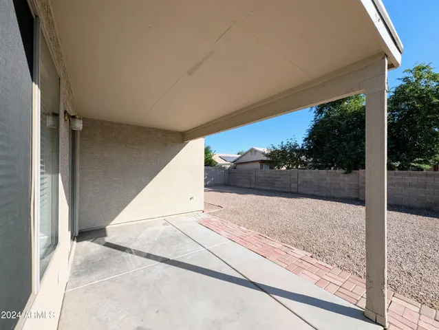a white house with a large tree in the background
