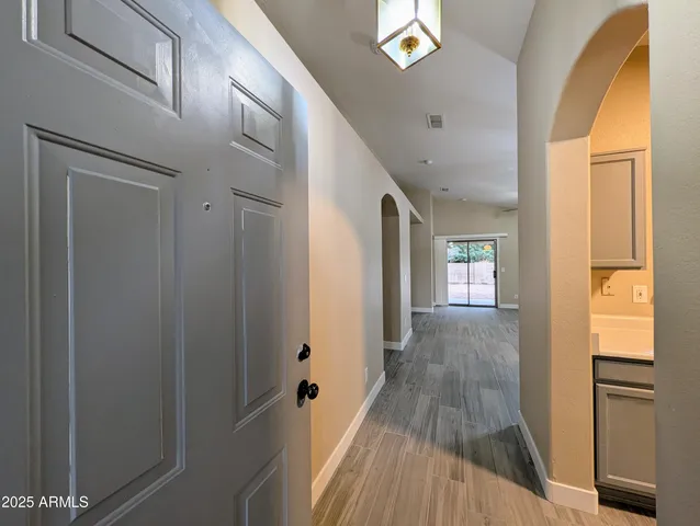 a view of a hallway with wooden floor and staircase