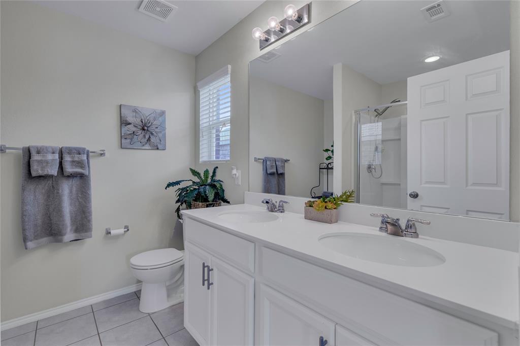 2208 Heaton Street Forney, TX 75126 - Photo 18 of 38 a bathroom with a sink toilet and shower