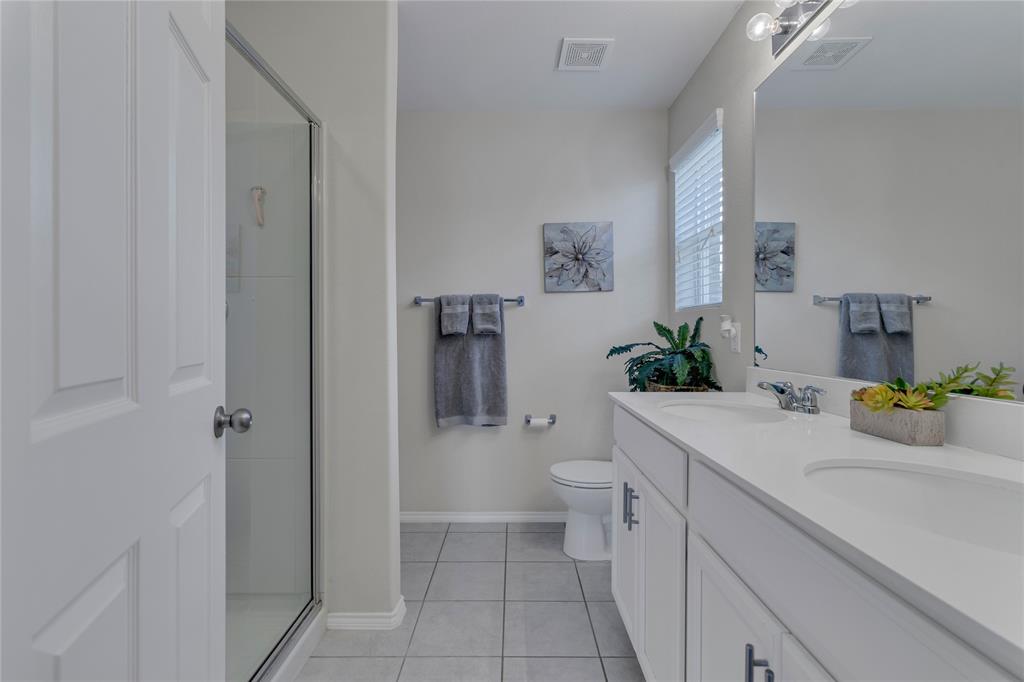 2208 Heaton Street Forney, TX 75126 - Photo 19 of 38 a bathroom with a sink a toilet and shower