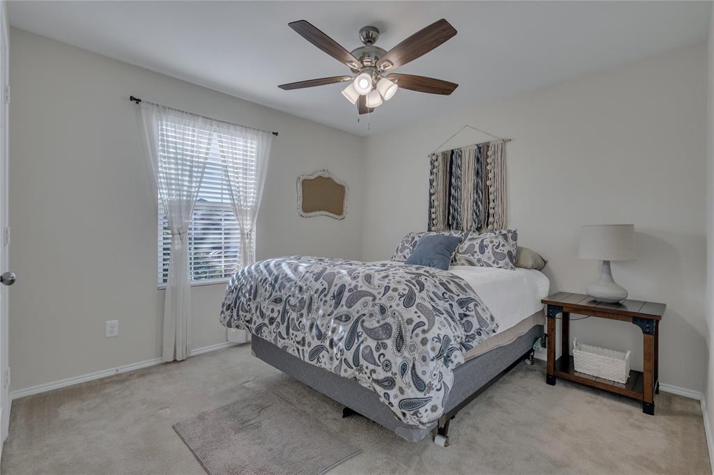 2208 Heaton Street Forney, TX 75126 - Photo 20 of 38 a bedroom with a bed and a ceiling fan