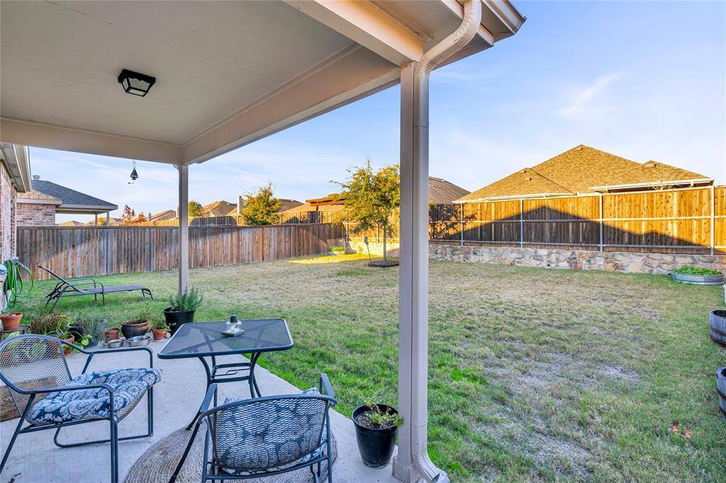 2208 Heaton Street Forney, TX 75126 - Photo 23 of 38 a backyard of a house with table and chairs potted plants