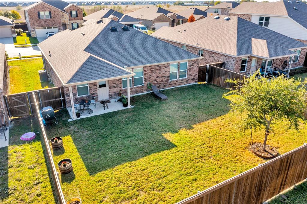 2208 Heaton Street Forney, TX 75126 - Photo 25 of 38 a view of a backyard with table and chairs