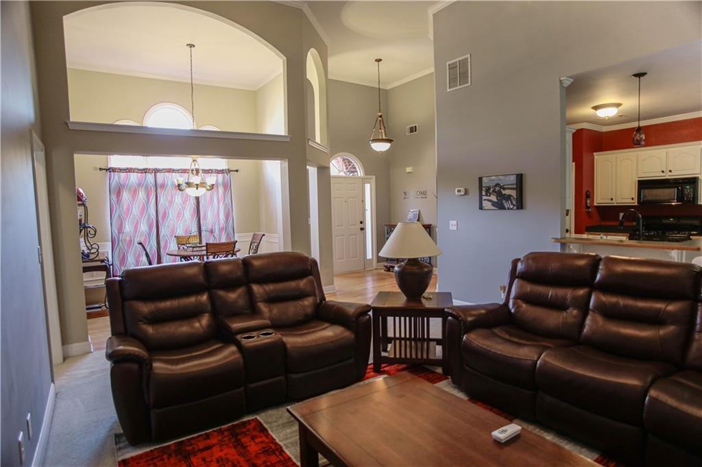 3875 Spring Manor Court Loganville, GA 30052 - Photo 8 of 23 a living room with furniture and a flat screen tv