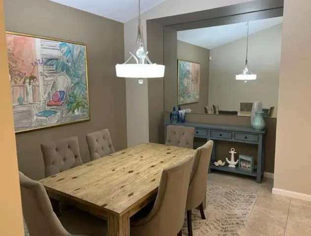 a dining room with furniture and wooden floor