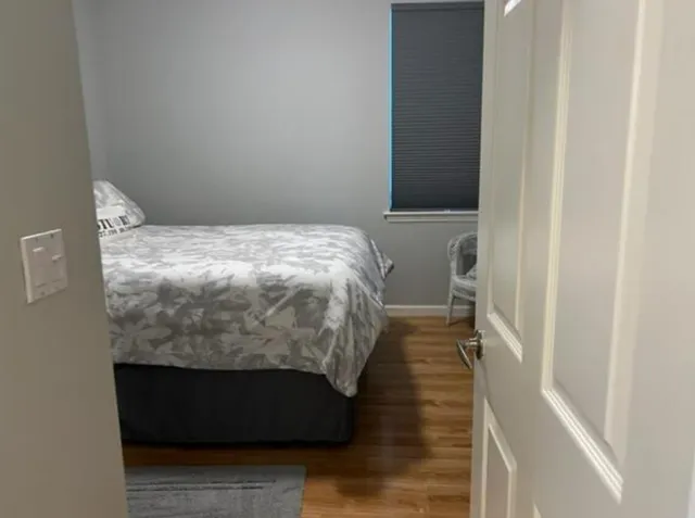 a bed sitting in a bedroom next to a small yard