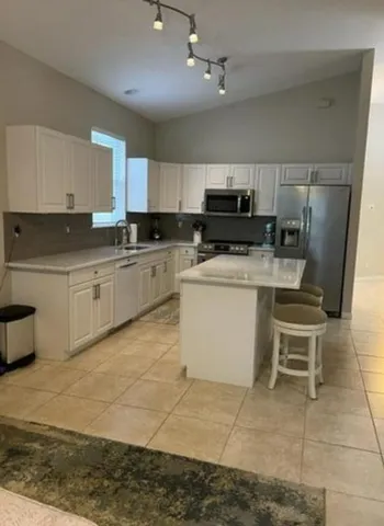 a kitchen with a sink a stove and cabinets